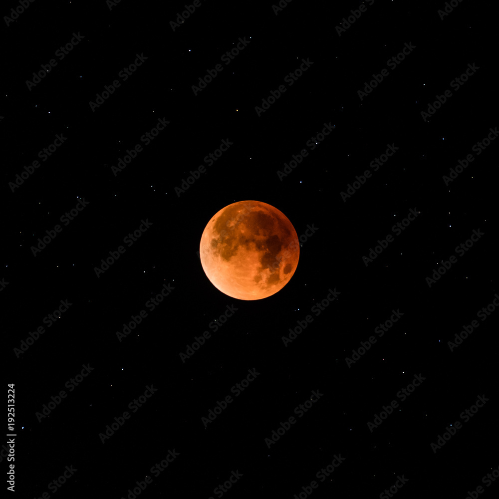 Full moon lunar eclipse against starry sky