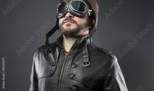 Slika na platnu old airplane pilot with brown leather jacket, arador hat and large glasses