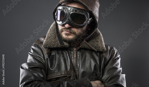 recreation of the Second World War, old airplane pilot with brown leather jacket, cap of avidor and large glasses