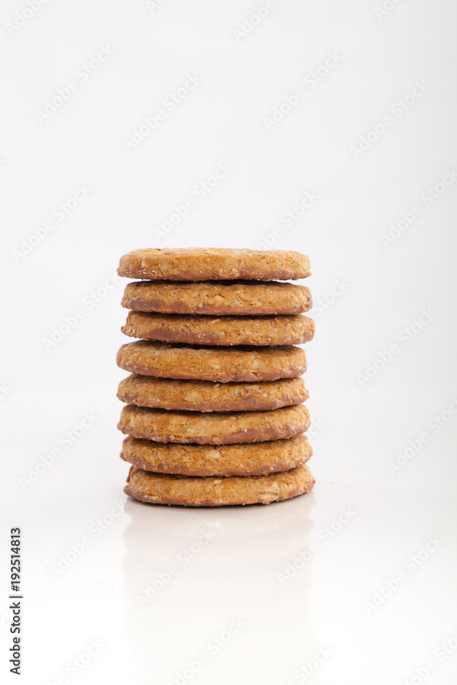 piles of round cookies on studio white background piles of round cookies on studio white background