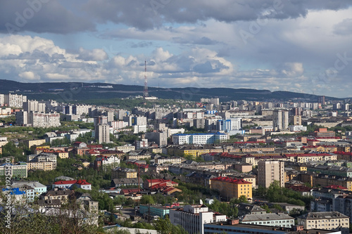 The urban landscape of the Murmansk Soviet architecture and the bright foliage of summer.