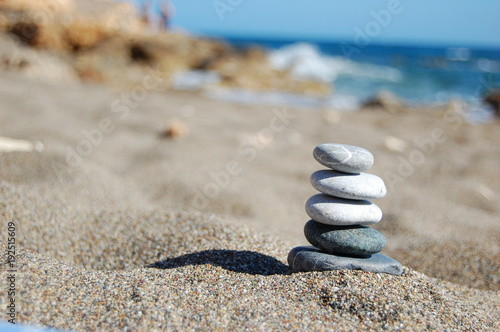 Balance of stones on the beach  sunny day