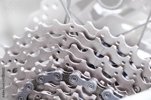 Bicycle gear and disk brake detail, close up shot of new and clean silver mountainbike metal chain rings 