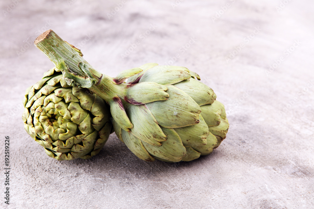 Fototapeta premium artichokes on grey background. fresh organic artichoke flower.