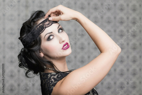 Fotografija brunette in black dress in the style of decadence