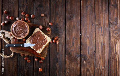 Homemade hazelnut spread with toast and in wooden bowl for breakfast. Hazelnut Nougat cream photo