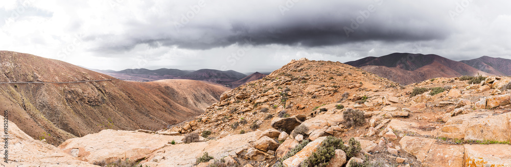 panoramic shot of volcanic mountainous landscape on island of Fuerteventura, Spain und overcast sky