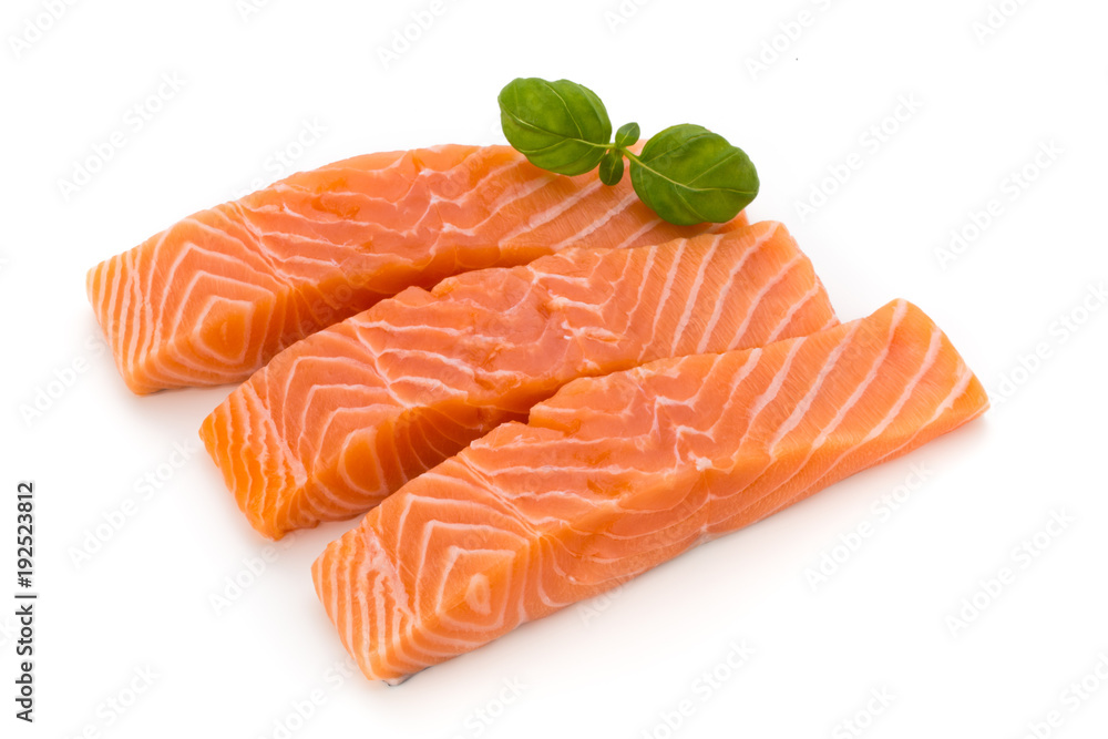 Fresh salmon fillet with basil on the white background.