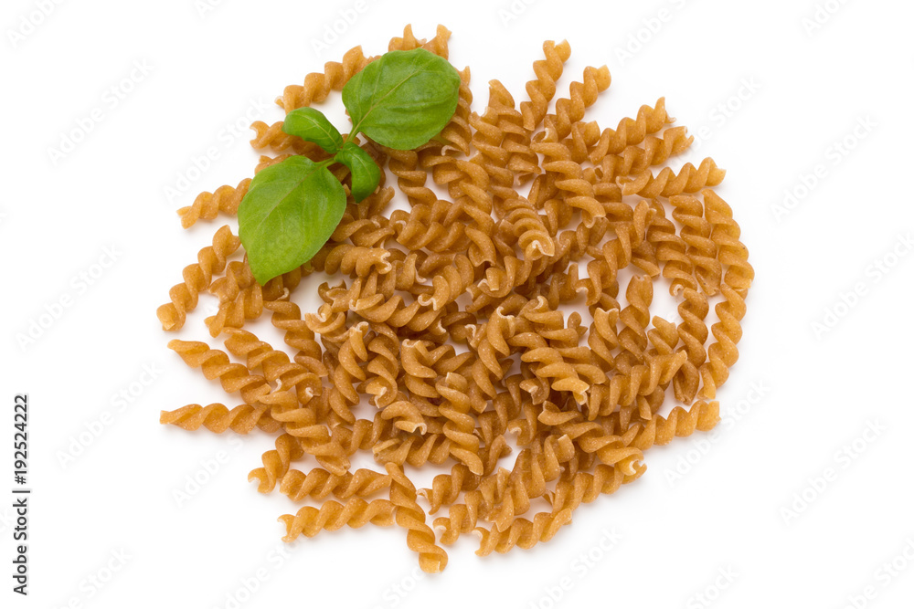 Fototapeta premium Uncooked wholemeal pasta isolated white background.