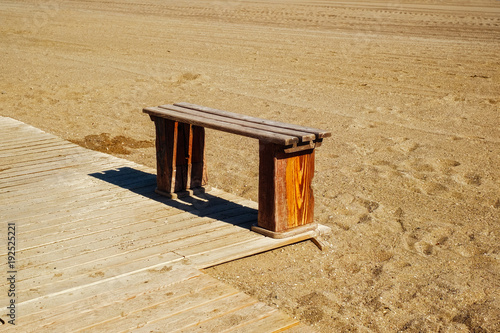wooden bench on the beach photo