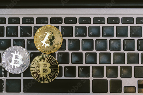 golden bitcoins on notebook keyboard