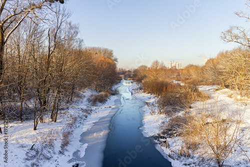 Frosty morning landscape with ice river and snow © O.Farion
