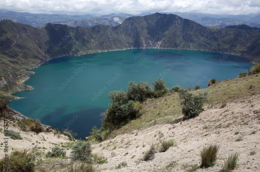 A view of Quilotoa Lake, an ancient volcano and starting point for the Quilotoa Loop hike A view of Quilotoa Lake, an ancient volcano and starting point for the Quilotoa Loop hike