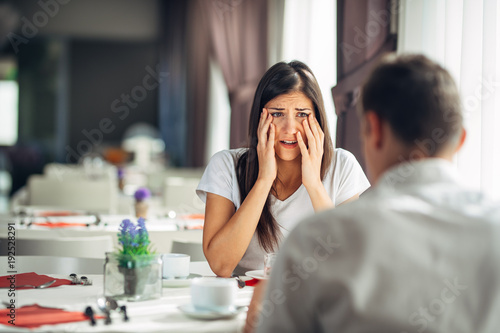 Shocked woman handling bad news,not believing negative event.Stressed crying female having relationship problems.Scandal,family affair.Divorce,break up.Cheated woman reaction.Finding out the truth. photo