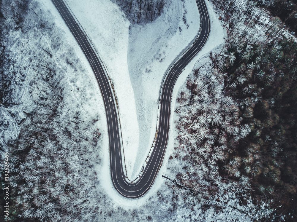 mountain road on a winter snowy day top down view