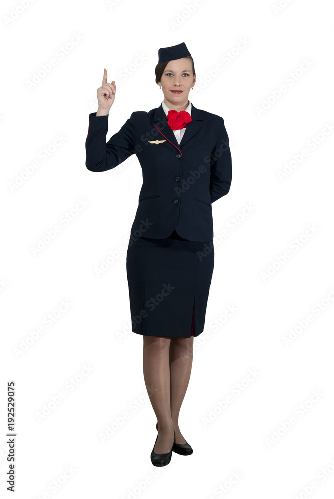 stewardess in full growth on a white background stands and shows the index finger up stewardess in full growth on a white background stands and shows the index finger up