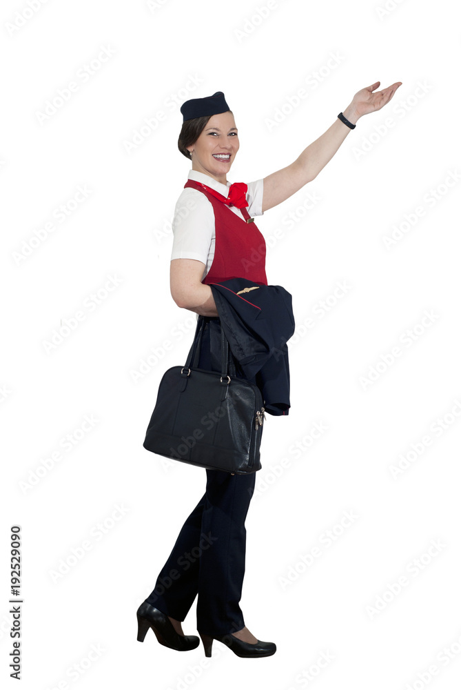 stewardess in full growth on a white background steps, smiles and shows