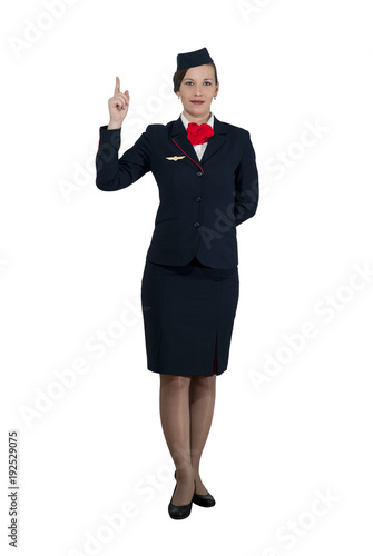 stewardess in full growth on a white background stands and shows the index finger up