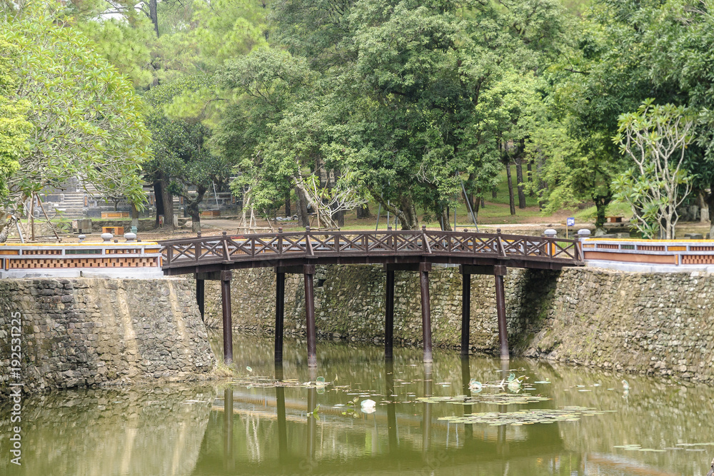 bridge in the pond inside the complex of the mausoleum of the emperor Tu Duc in Hue, Vietnam.