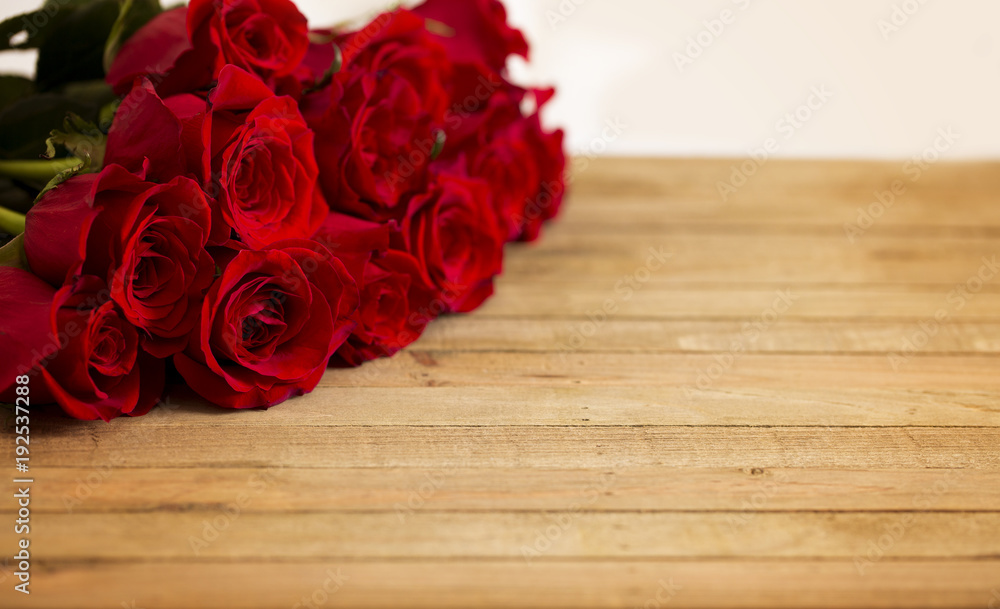 Beautiful Red Valentines Roses on a Wooden Table