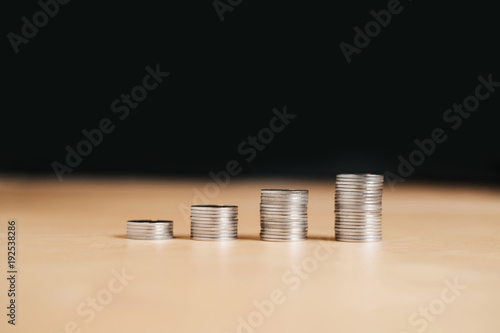 Increasing columns of coins, step of stacks coin with copy space for business and financial concept idea.