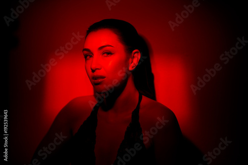 sexy fiery girl in red. Portrait of a beautiful sexy girl in red  background.