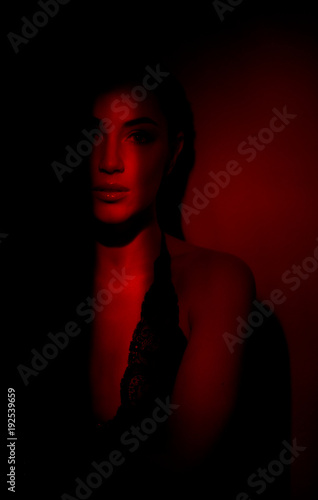 sexy fiery girl in red. Portrait of a beautiful sexy girl in red  background.