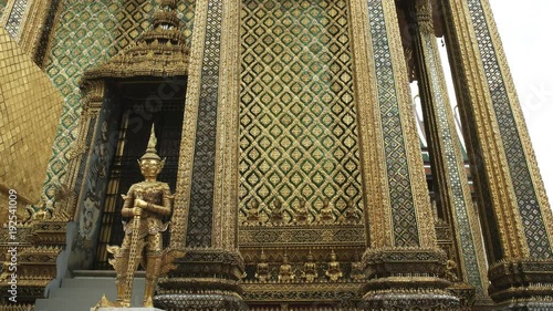 a gilded statue at thewat phra kaew temple complex in bangkok, thailand photo