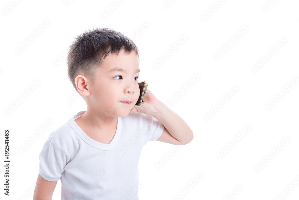 Little asian boy wearing white t-shirt and talking via mobile phone over white background Little asian boy wearing white t-shirt and talking via mobile phone over white background