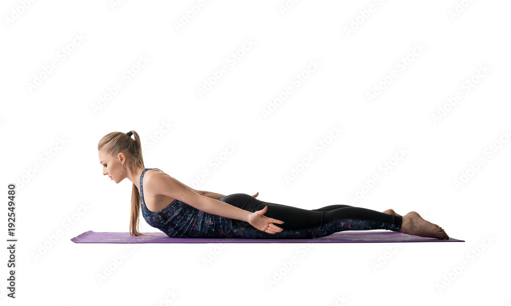 Young girl doing sports exercises on a mat view Young girl doing sports exercises on a mat view