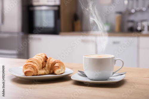 Croissant And Cup Of Coffee At Breakfast