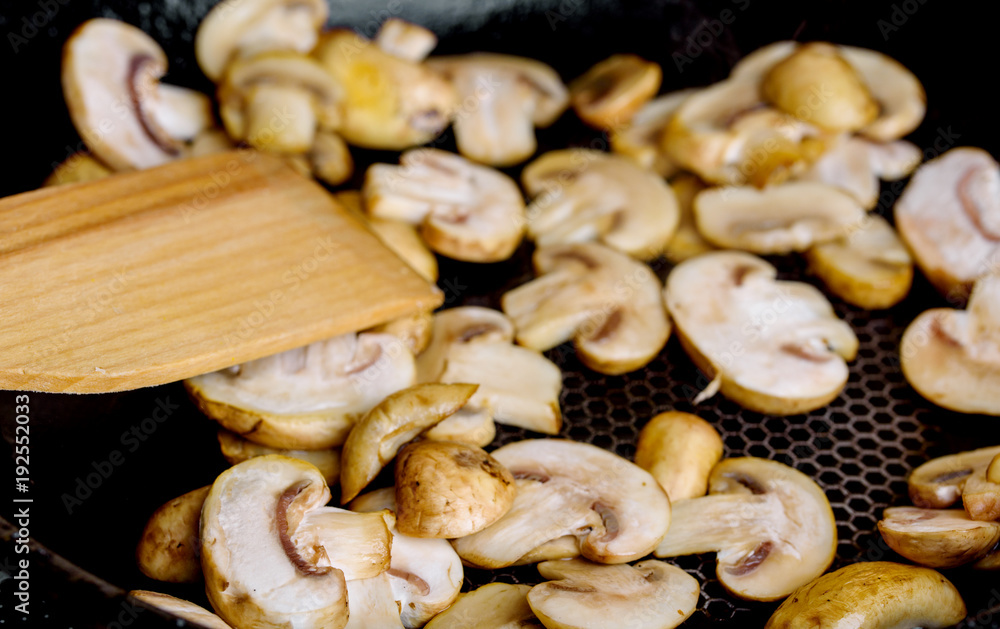 Fried mushrooms in a hot frying pan on an electric stove Fried mushrooms in a hot frying pan on an electric stove