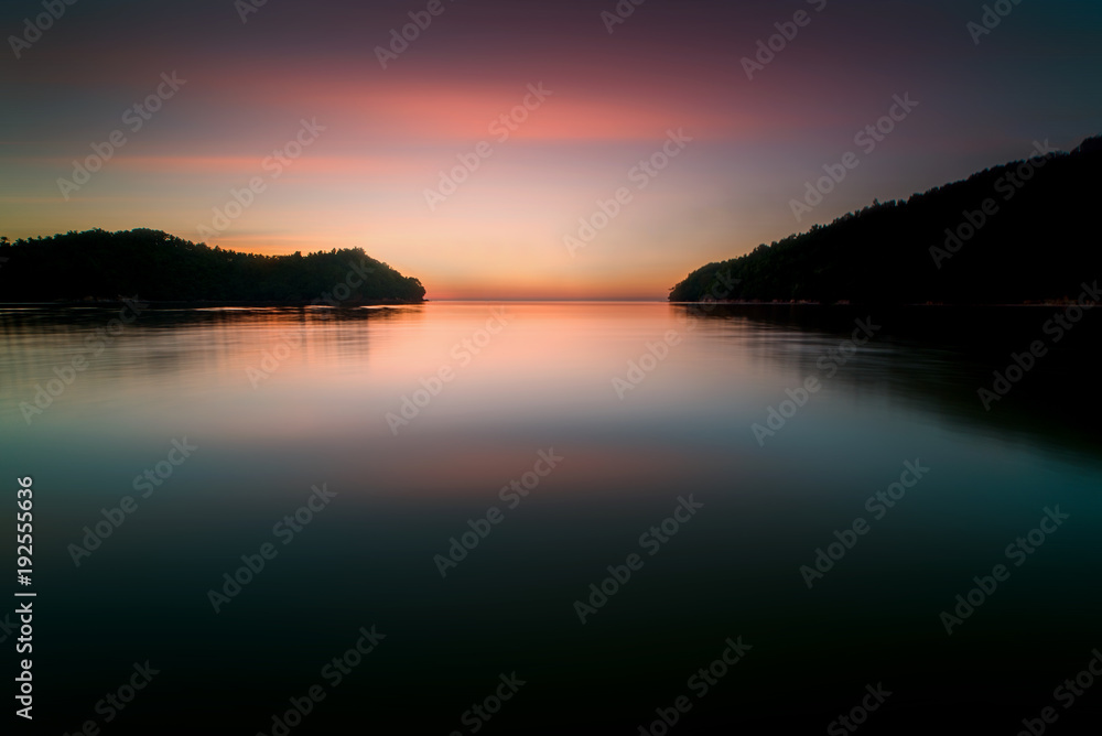 long expose sunset seascape with waves trails. image contain soft focus due to slow shutter.