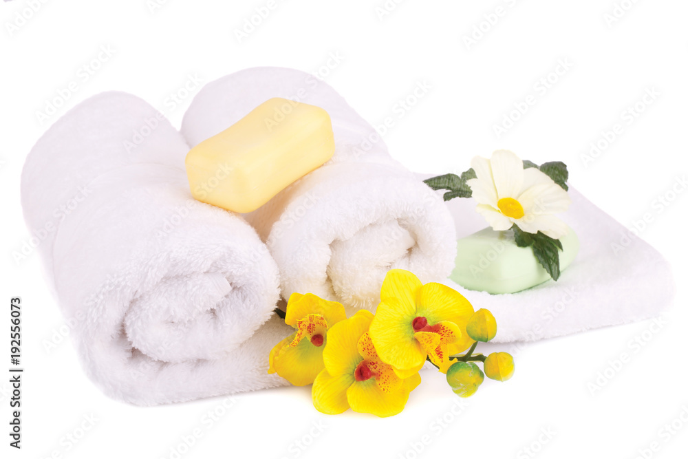 White rolled towels with soap bars and flowers White rolled towels with soap bars and flowers