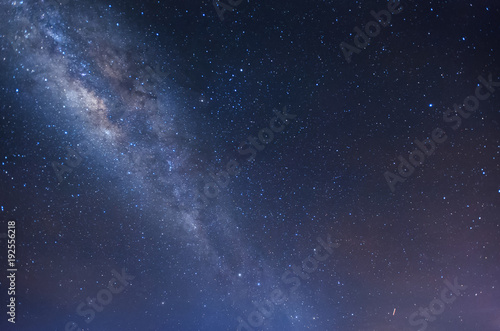 Milkyway rise above a lone tree during starry night sky. image content soft focus, blur and noise due to long expose and high iso.