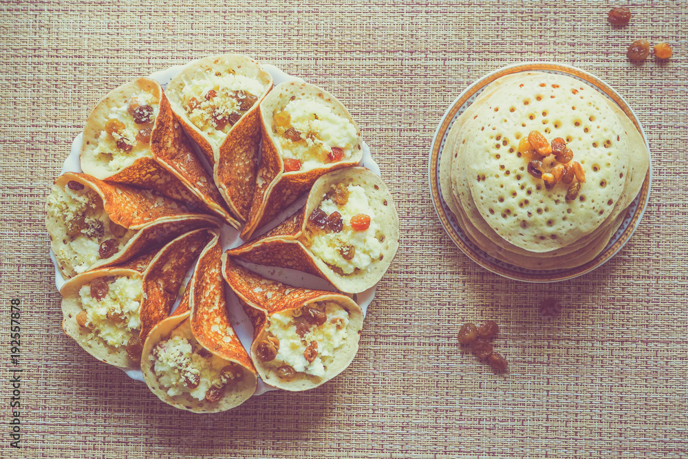Moroccan pancakes with herbal tea. Middle Eastern food.
Moroccan pancakes with herbal tea. Middle Eastern food.