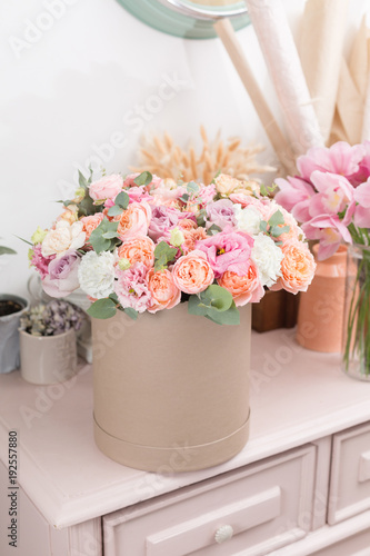 beautiful luxury bouquet of mixed flowers in kraft box. the work of the florist at a flower shop.