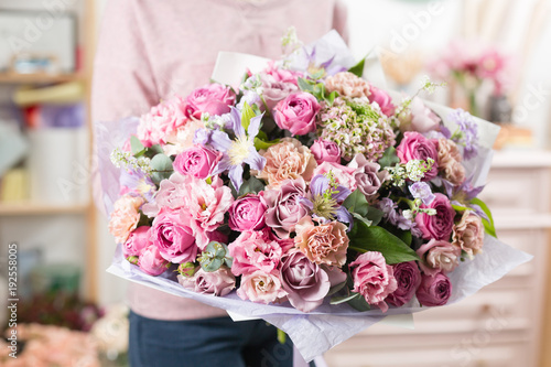 beautiful luxury bouquet of mixed flowers in woman hand. the work of the florist at a flower shop.