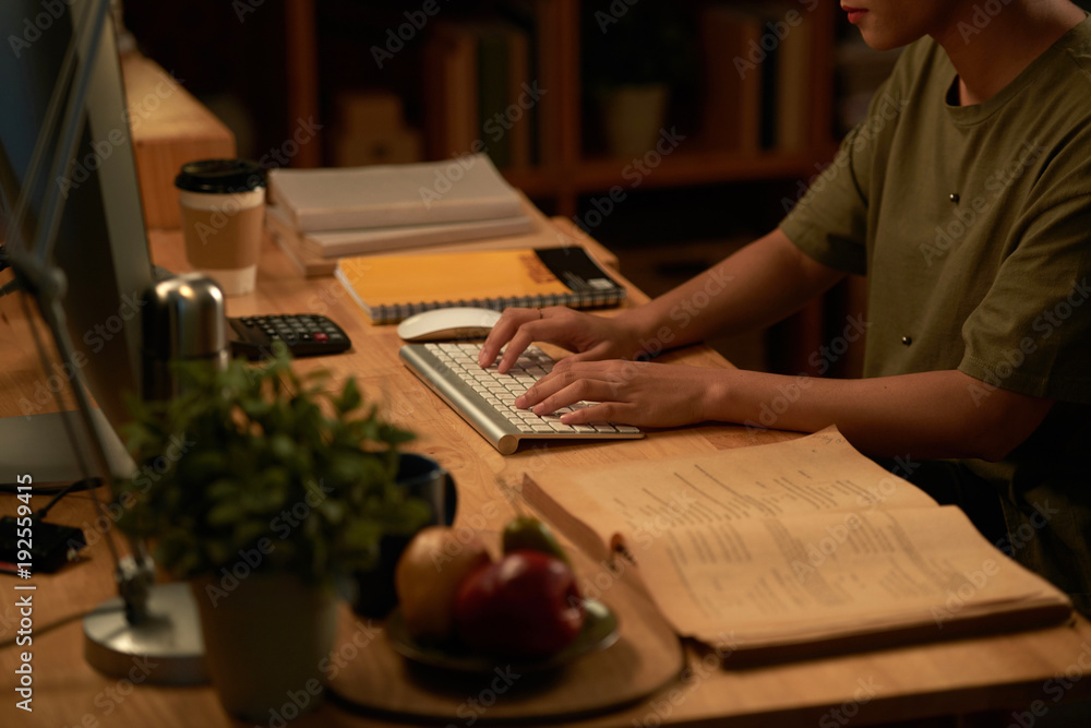 Student typing on computer Student typing on computer