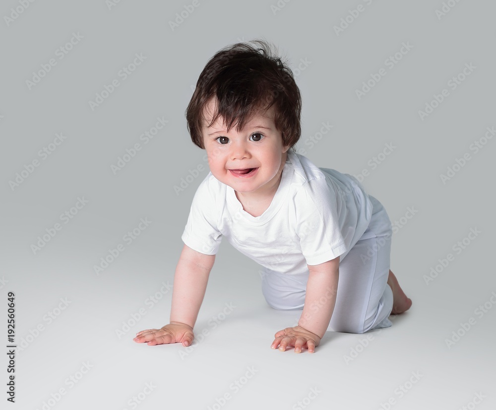 Happy crawling baby. Side view Happy crawling baby. Side view