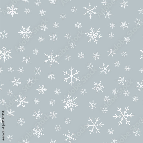 White snowflakes seamless pattern on light grey Christmas background. Chaotic scattered white snowflakes. Interesting Christmas creative pattern. Vector illustration.