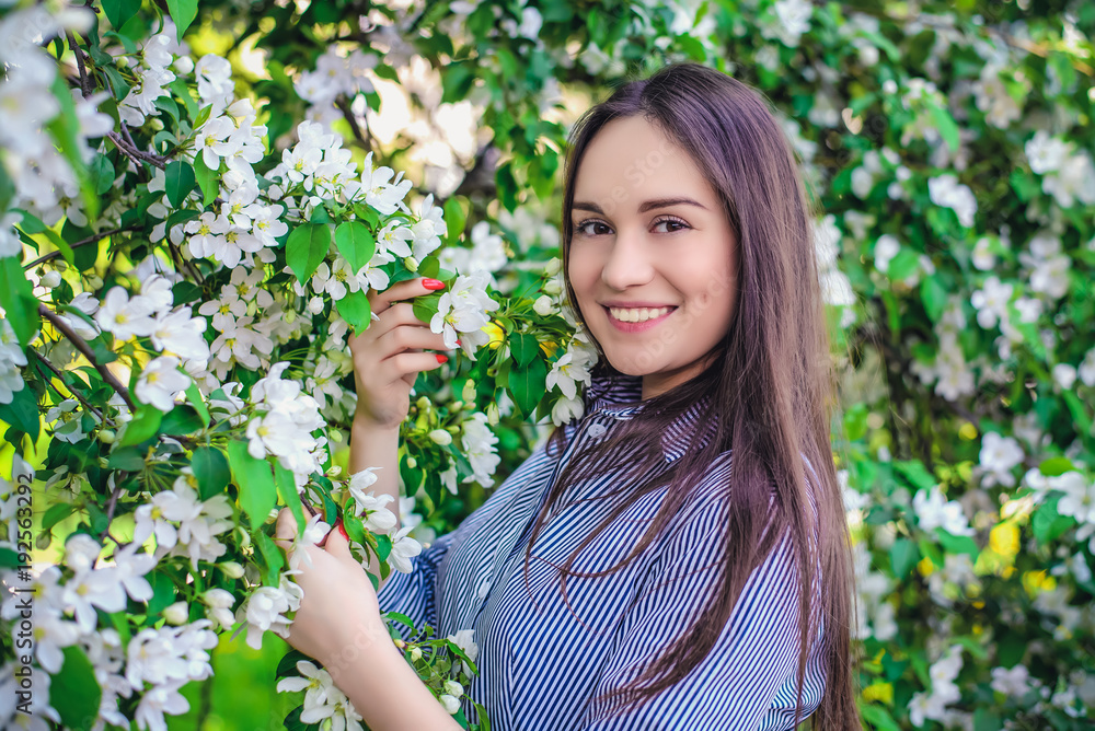 Beautiful girl near blooming apple trees in spring Beautiful girl near blooming apple trees in spring