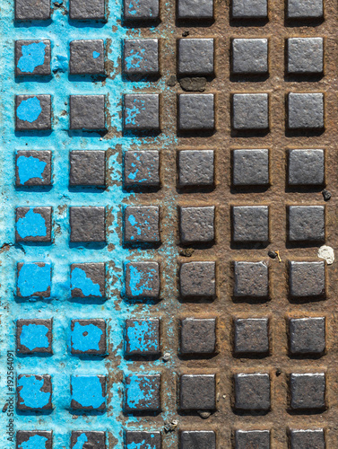 Close - up of a brown and blue manhole cover