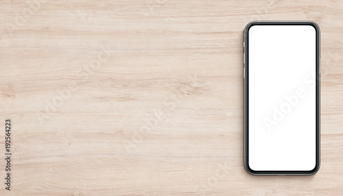 Smartphone mockup flat lay top view lying on wooden office desk banner with copy space