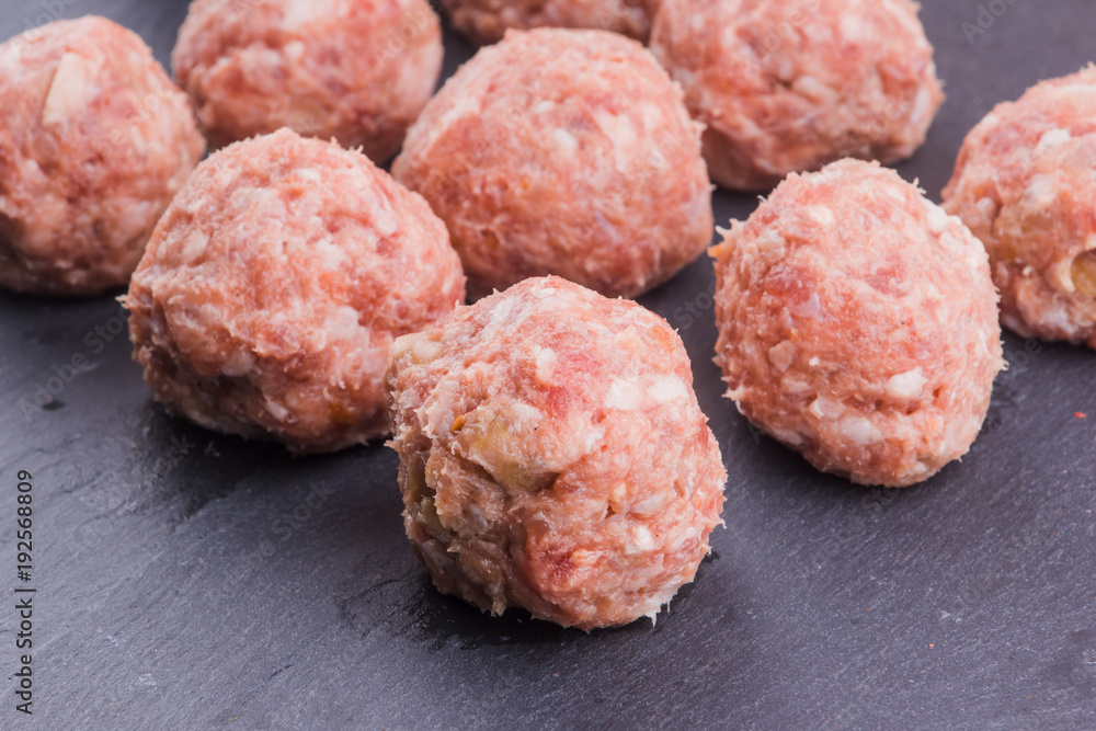 Fresh raw meat balls with dark background close-up Fresh raw meat balls with dark background close-up