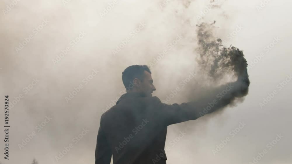 The abstract concept of protest close up. Human with smokebomb stand outside, clouds of fumes pollute air. Courage, daring, bravery and cheerfulness life style. Motivation picture of business career The abstract concept of protest close up. Human with smokebomb stand outside, clouds of fumes pollute air. Courage, daring, bravery and cheerfulness life style. Motivation picture of business career