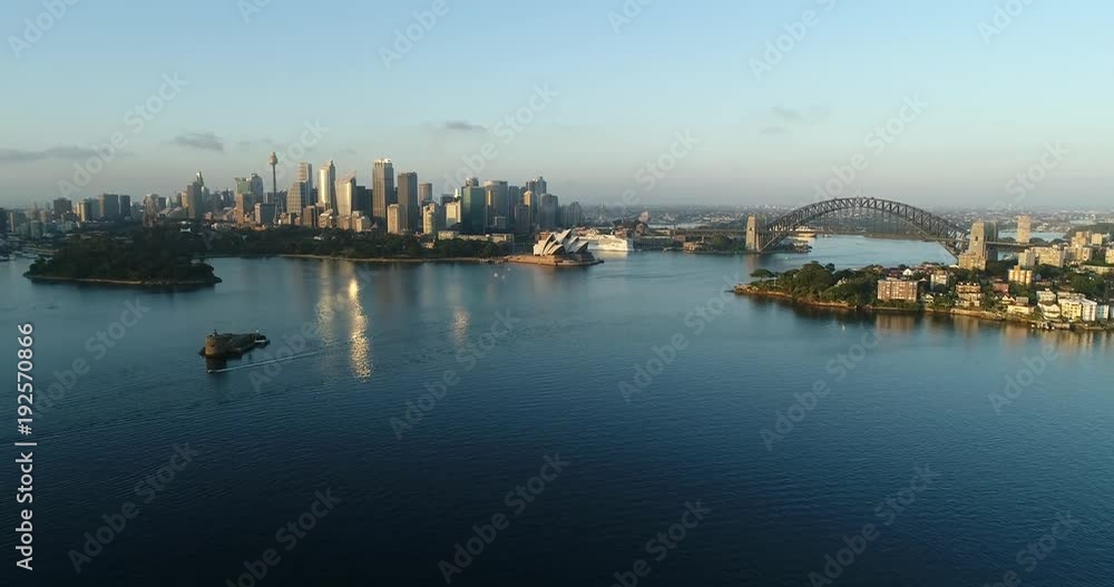 Rising up above Sydney harbour waters towards city CBD landmarks and the Sydney Harbour bridge on calm summer morning.
Rising up above Sydney harbour waters towards city CBD landmarks and the Sydney Harbour bridge on calm summer morning.