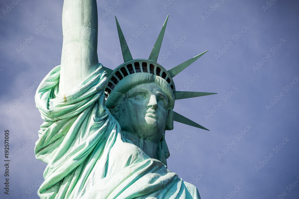 Fototapeta premium The statue of Liberty. Close-up, with some space on the right. Dramatic background.