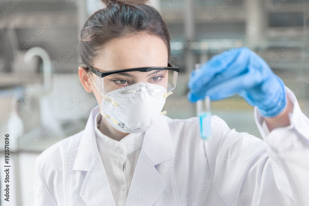 Female scientist looking at the sample in laboratory Female scientist looking at the sample in laboratory