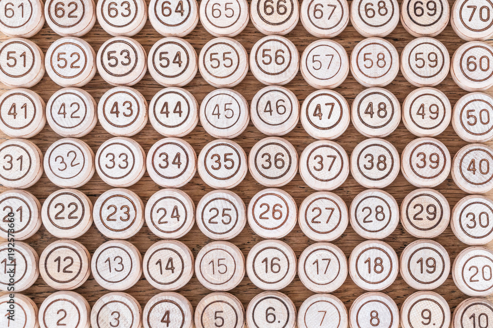 Layed out in order on a wooden table kegs of lotto with numbers Layed out in order on a wooden table kegs of lotto with numbers